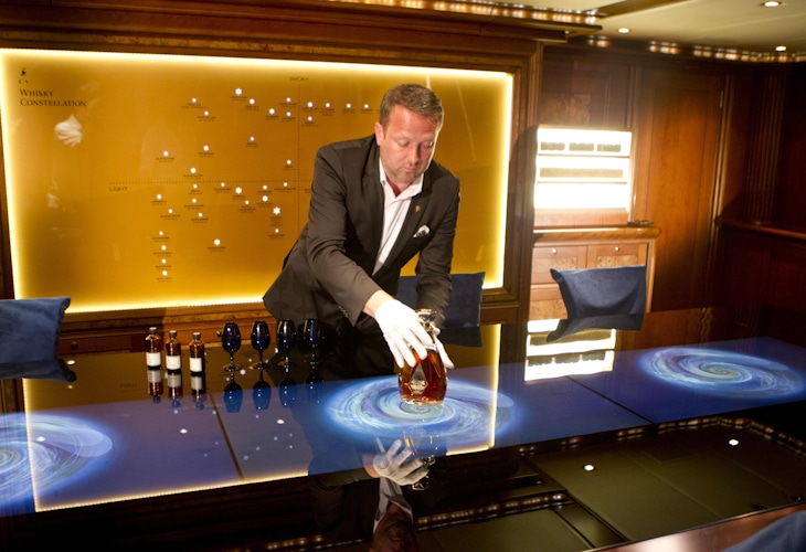 Johnnie Walker Voyager Odyssey Worldwide pop-up brand experience design by Studio Königshausen. We altered the 57-meter-long sailing yacht to an actual Johnny Walker experience. The Voyager contains four areas for guest use. These include the Voyager Sundeck entertainment and bar, Odyssey Reception area, Johnnie Walker Blue Label Game Changers Lounge and Around the World suite.